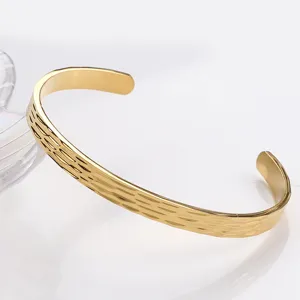 Golden titanium steel C-shaped cuff bracelet with textured hammered surface for daily fashion wear.