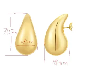 Gold teardrop earring detail showing smooth high gloss metal surface and secure pin closure.