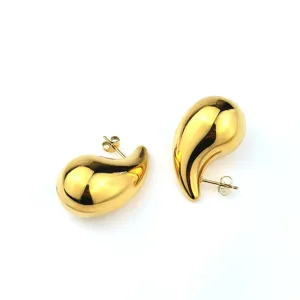 Close-up detail of the smooth polished teardrop gold stud earrings, showcasing refined metal texture.