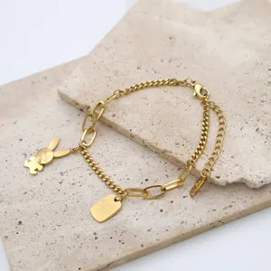 Gold stainless steel chain bracelet with cute rabbit pendant and paperclip link details.
