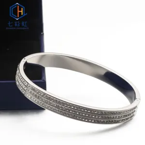 Close-up detail of a stylish stainless steel triple-row crystal pave bangle bracelet.
