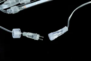 Waterproof LED string light connector detail view, transparent plug and screw cap.