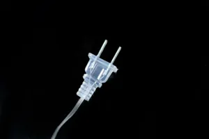 Clear two-prong electrical plug and transparent wire detail for LED string lights accessory.