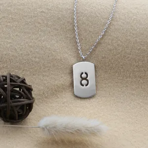 Detailed close-up of the silver metal dog tag necklace featuring a hollow number 8 design.