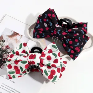 Detailed shot of cute cherry print fabric hair claw bows in black and white styles, stylish.