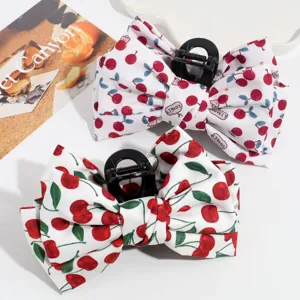 Cute cherry print hair claw bow detail showing sweet fabric bow and black shark clip.