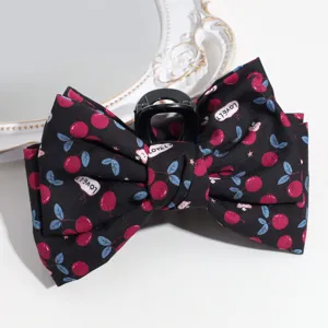 Close-up detail of the sweet cherry print fabric bow hair claw clip, elegant and charming.