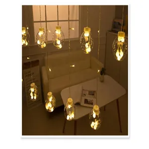Close-up detail of warm white LED wish ball string lights hanging in a cozy living room decor.