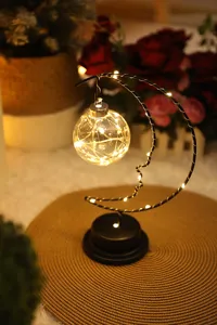 Charming moon LED night light with hanging glass ball, cozy bedroom decor lighting.