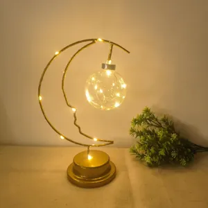 Warm LED moon night light detail with hanging glowing globe for cozy bedroom ambient lighting.