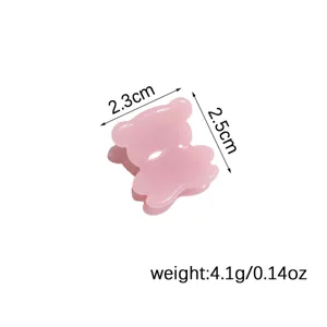 Detailed view of the cute pink bear mini hair claw clip, showing precise size and weight.