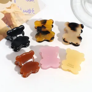 Detailed view of cute mini bear hair claw clips in various colors, perfect for styling.