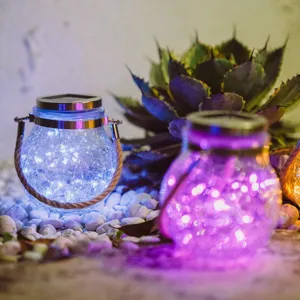 Close-up detail of outdoor solar crackle glass jar LED hanging lantern with blue and purple lights.