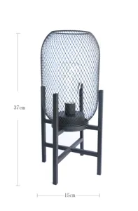 Detailed view of the metal mesh lantern decorative night light with black iron stand.
