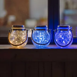 Detailed shot of solar crackle glass lanterns with LED string lights for outdoor garden decor.