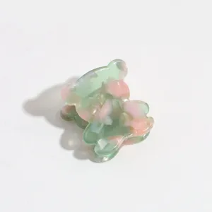 Mini bear hair claw clip in green and pink acetate, perfect for cute styling details.