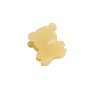 Mini translucent yellow bear hair claw clip, cute styling side bang hair accessory for women.