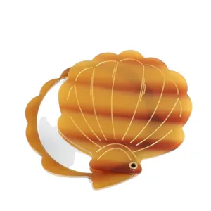 Portable seashell folding makeup mirror with gold lines, stylish pocket mirror for daily touchups.