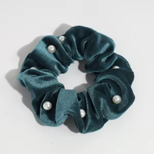 Dark green velvet hair scrunchie with white pearl details, elegant hair accessory for daily wear.