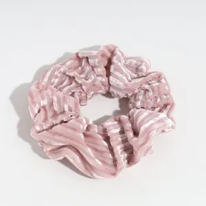 Pink velvet hair scrunchie detail shot, soft striped hair tie for daily ponytail styling.