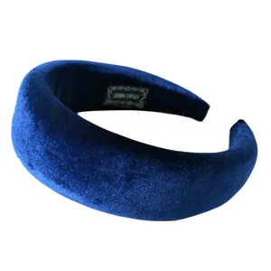 Detailed close-up of the royal blue velvet padded headband, showing soft texture and fine stitching.