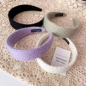 Detailed view of fluffy plush wide hair hoops in assorted candy colors, soft texture.
