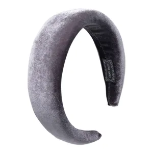 Detailed close-up of a wide padded velvet headband in dark grey, showing soft texture and quality.