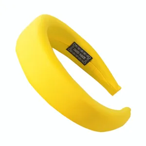 Yellow sponge padded headband detail, wide fabric hair hoop closeup showing hand made label.