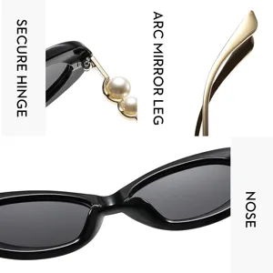 Detail view of vintage oval sunglasses with pearl decorated hinge and curved temples.