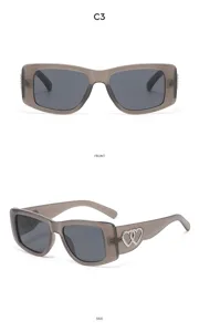 Vintage cat-eye sunglasses for women, grey translucent frame with double heart rhinestone temples.