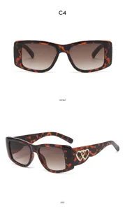 Detailed view of retro tortoiseshell cat-eye sunglasses with gold heart temple accents.