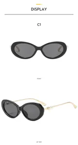 Detail view of retro oval sunglasses featuring black frames and elegant pearl temple accents.