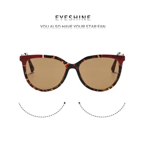 Details of retro cat-eye sunglasses with tortoise frame and red brow line for women.