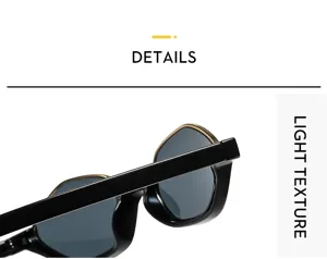 Primer plano detallado de gafas de sol poligonales modernas con montura negra y borde dorado.