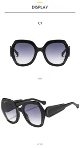 Vue détaillée de lunettes de soleil tendance surdimensionnées noires à verres dégradés.