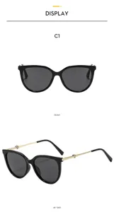 Detail close up view of cat eye sunglasses featuring metal temples and heart rhinestone.