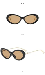 Details of retro oval sunglasses with black frame, brown lenses, and delicate pearl temples.