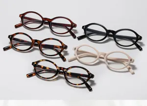Close-up of vintage oval optical frames with stylish rivet details in multiple colors and finishes.