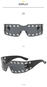 Detailed view of Y2K punk shield sunglasses with metal grommets and black frames.