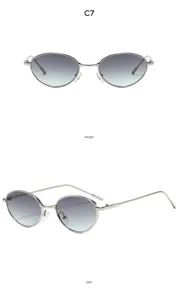 Dettaglio di occhiali da sole ovali vintage in metallo con lenti sfumate alla moda trendy.
