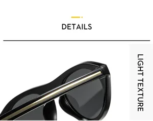 Gros plan de lunettes de soleil cat-eye noires élégantes avec barre supérieure dorée.