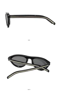 Lunettes de soleil ovales noires avec incrustation dorée, idéales pour la mode et la conduite.