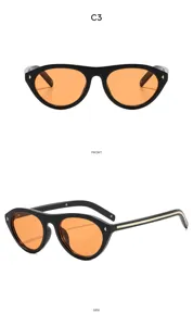 Lunettes de soleil œil-de-chat rétro pour femme, monture noire et verres orange pour l'extérieur.