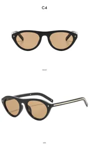 Vue détaillée de lunettes de soleil vintage œil-de-chat noires avec verres bruns et décors.