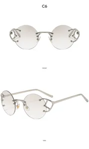 Gedetailleerd overzicht van trendy ronde rimless zonnebril met metalen detail aan de zijkant.