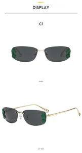 Lunettes de soleil carrées en métal sans monture avec décor de feuilles vertes tendance.