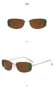 Lunettes de soleil carrées en métal sans monture avec décor de feuilles vertes, vue de face.
