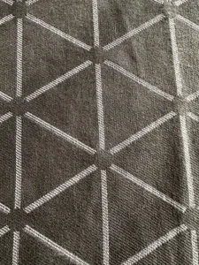 Close up view of the geometric woven jacquard fabric detail, showcasing clear texture and pattern.