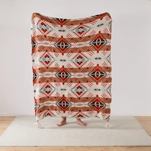 Knitted jacquard blanket showcasing intricate geometric patterns and cozy texture.