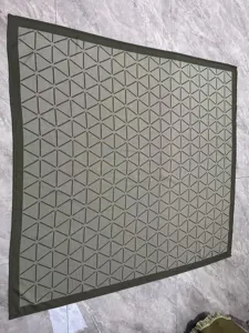 Geometric triangle jacquard woven blanket detail showcasing neat stitching and clear pattern.